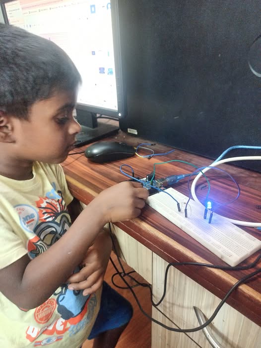 Kid working with breadboard and LED