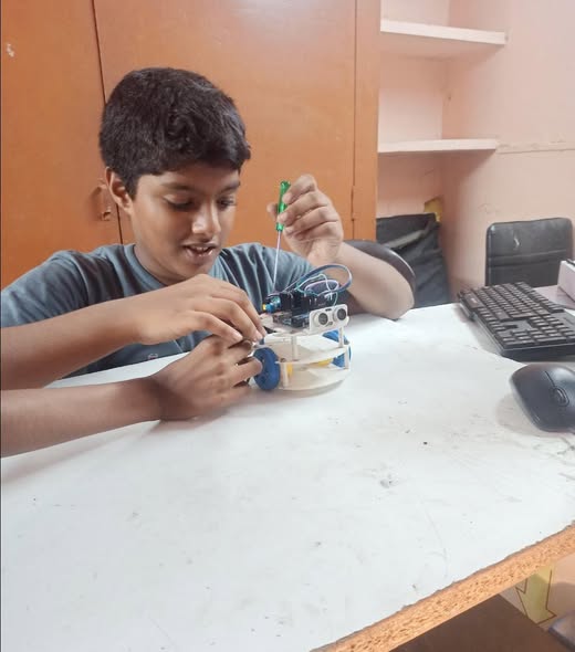 Kid assembling a robot