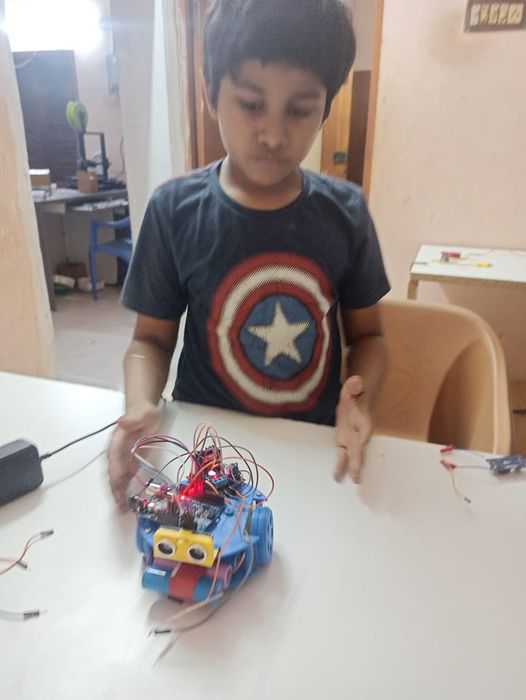 Kid building a robot car